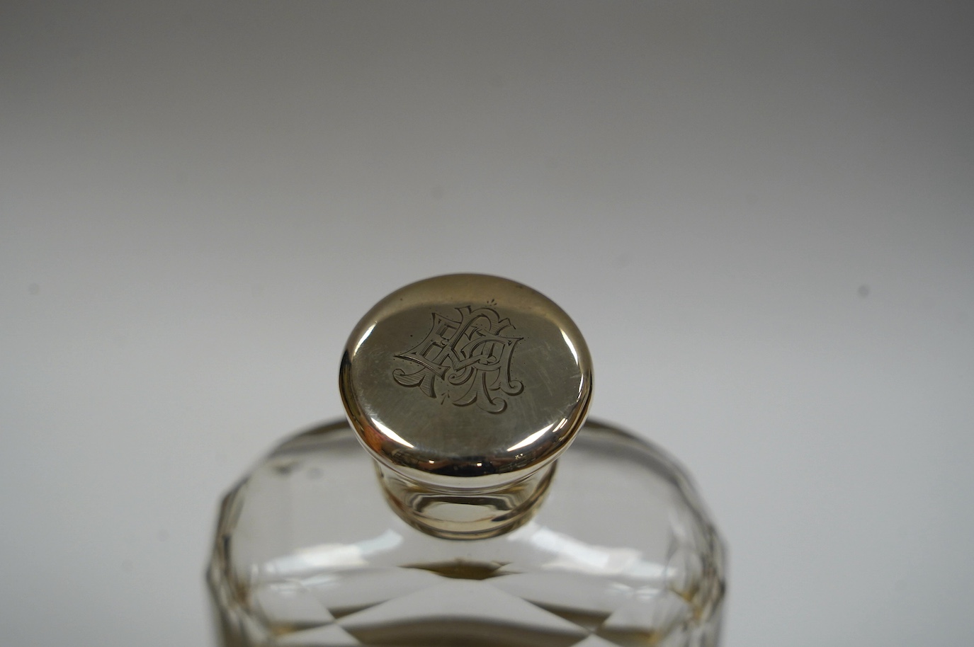 A Victorian silver mounted cut glass spirit flask, with engraved monograms, by Thomas Johnson II, London, 1876, 12cm. Condition - fair to good